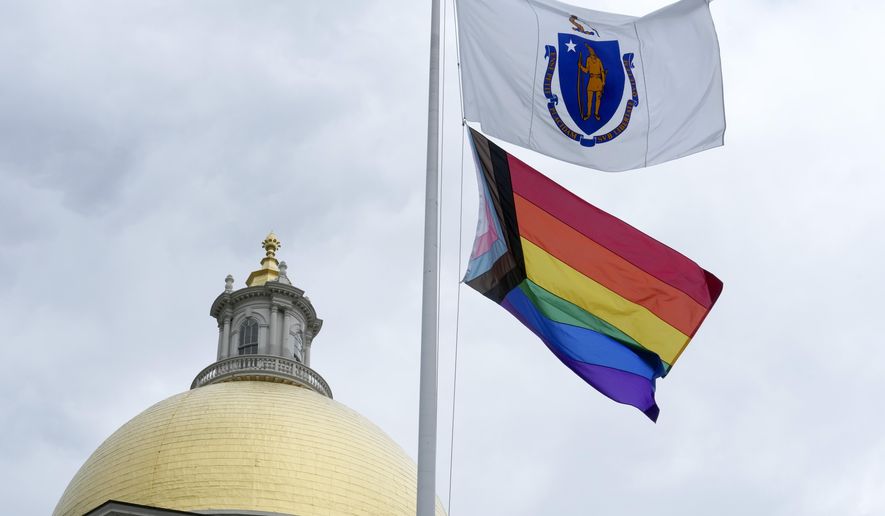 A Pride flag flies below a Massachusetts state flag in front of the Statehouse following a Pride Month Celebration, Wednesday, June 7, 2023, in Boston. Mass. Gov. Maura Healey said Massachusetts is a state that "prizes equality, protects freedoms, protects civil rights, protects the LGBTQ community, and that would be a broader message to people nationally." (AP Photo/Steven Senne)