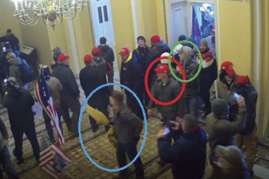 In this image from U.S. Capitol Police video, released and annotated by the Justice Department in the Statement of Facts supporting an arrest warrant, Joshua Abate, circled in green, Micah Coomer, circled in red, and Dodge Dale Hellonen, circled in blue, appear inside the U.S. Capitol on Jan. 6, 2021, in Washington. Abate and Hellonen, who were active-duty members of the Marines Corps when they stormed the U.S. Capitol, pleaded guilty on Monday, June 12, 2023, to riot-related criminal charges. Coomer, who was an active-duty Marine, pleaded guilty to the same misdemeanor charge in May. (Justice Department via AP)
