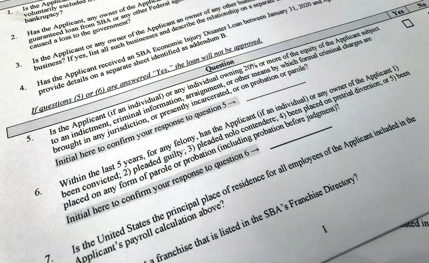 A portion of a Small Business Administration Paycheck Protection Program Borrower Application Form is seen in Washington on Tuesday, April 21, 2020. An Associated Press analysis published on Monday, June 12, 2023, found that fraudsters potentially stole more than $280 billion in COVID-19 relief funding; another $123 billion was wasted or misspent. Combined, the loss represents a jarring 10 percent of the total $4.2 trillion the U.S. government has so far disbursed in COVID-relief aid. (AP Photo/Wayne Partlow, File)