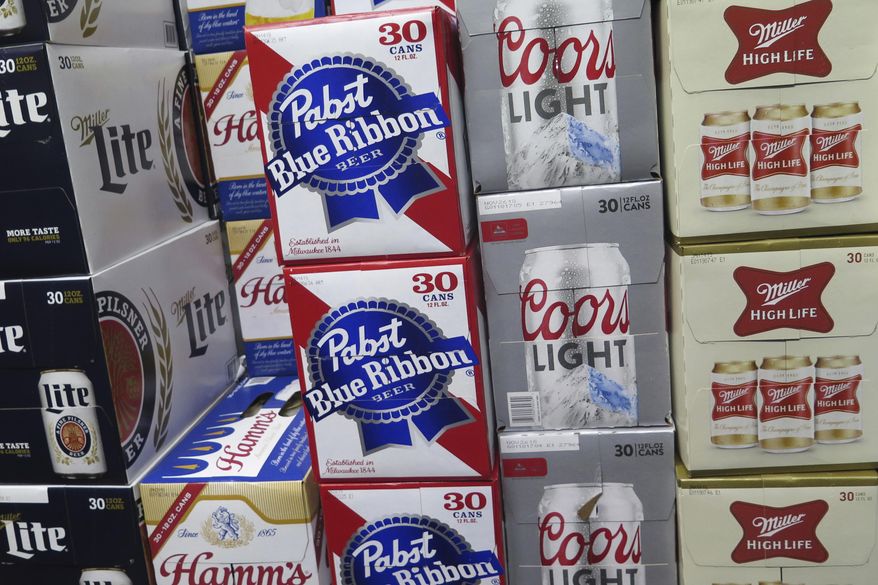 In this Nov. 8, 2018, file photo, cases of beer are stacked next to each other in a Milwaukee liquor store. Wisconsin's alcohol industry is getting behind an overhaul of the state’s alcohol laws that would lead to stricter enforcement efforts The measure has been hammered out in secret the past five years largely between Republican lawmakers and the multi-billion dollar alcohol industry. (AP Photo/Ivan Moreno, File)