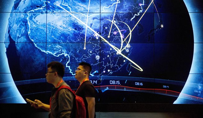 Attendees walk past an electronic display showing recent cyberattacks in China at the China Internet Security Conference in Beijing, on Sept. 12, 2017. Hackers linked to China were likely behind the exploitation of a software security hole in cybersecurity firm Barracuda Networks鈥� email security feature that affected public and private organizations globally, according to an investigation by security firm Mandiant. (AP Photo/Mark Schiefelbein) **FILE**