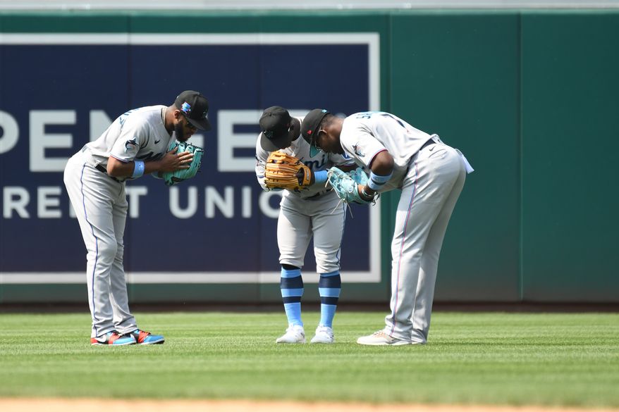 Miami Marlins outfielders Bryan De La Cruz (14), Jonathan Davis (49) and Jorge Soler (12) celebrate after the Marlins’ 4-2 victory over the Washington Nationals at Nationals Park in Washington D.C., June 18, 2023. (Photo by Billy Sabatini/All-Pro Reels)