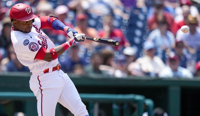 Washington Nationals&#x27; Victor Robles hits a single during the third inning of a baseball game against the Miami Marlins at Nationals Park, Sunday, June 18, 2023, in Washington. (AP Photo/Alex Brandon)