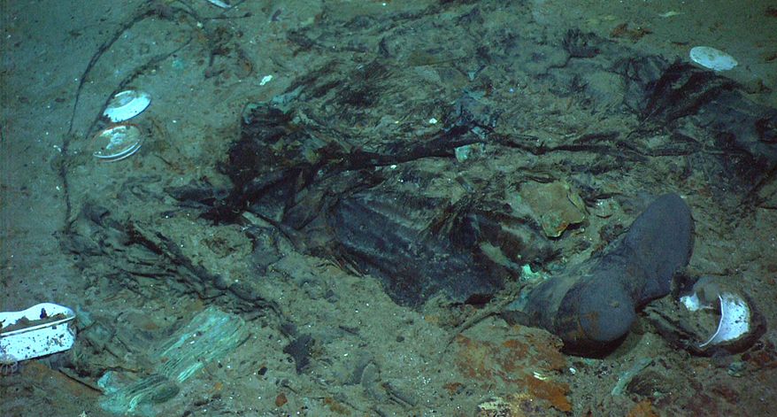 This 2004 photo provided by the Institute for Exploration, Center for Archaeological Oceanography/University of Rhode Island/NOAA Office of Ocean Exploration, shows the remains of a coat and boots in the mud on the sea bed near the Titanic's stern. (Institute for Exploration, Center for Archaeological Oceanography/University of Rhode Island/NOAA Office of Ocean Exploration) **FILE**