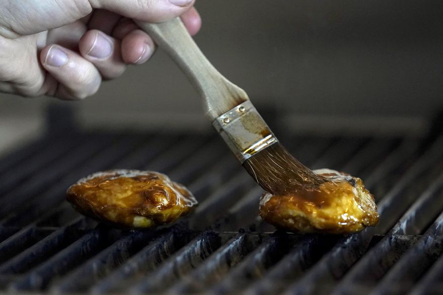 Chef Zach Tyndall prepares Good Meat's cultivated chicken at the Eat Just office in Alameda, Calif., Wednesday, June 14, 2023. The Agriculture Department issued final approvals Wednesday, June 21 to California firms Upside Foods and Good Meat to sell the products, known as “lab grown” or “cultivated” meat. (AP Photo/Jeff Chiu)