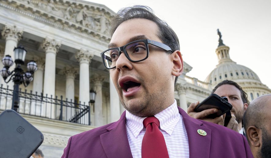 Rep. George Santos, R-N.Y., speaks to reporters outside the Capitol, in Washington, May 17, 2023. Santos, 34, has spent weeks fighting efforts by news outlets to unseal the names of the two people who co-signed the $500,000 bond, which enabled his pretrial release as he awaits federal charges of fraud, money laundering and theft of public funds. (AP Photo/J. Scott Applewhite, File)