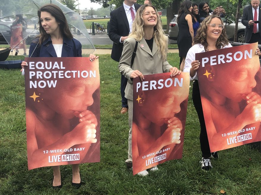 Pro-life activists supporting a federal ban on all abortions rallied outside the U.S. Capitol on Friday, a day before the first anniversary of the Supreme Court overturning Roe v. Wade. (Sean Salai / The Washington Times)