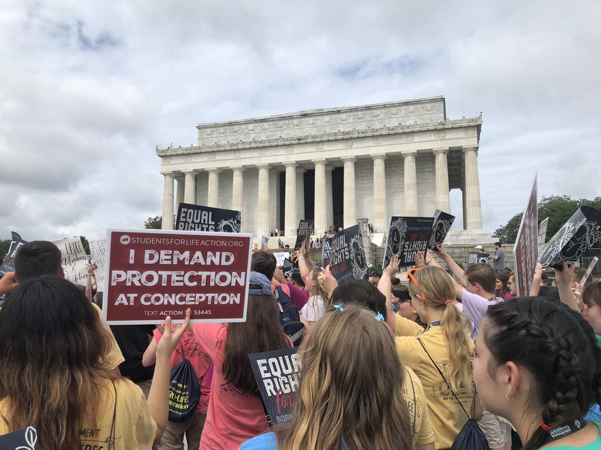 Roughly 2,000 pro-life activists celebrated the first anniversary of the end of Roe v. Wade Saturday at the Lincoln Memorial. (The Washington Times)