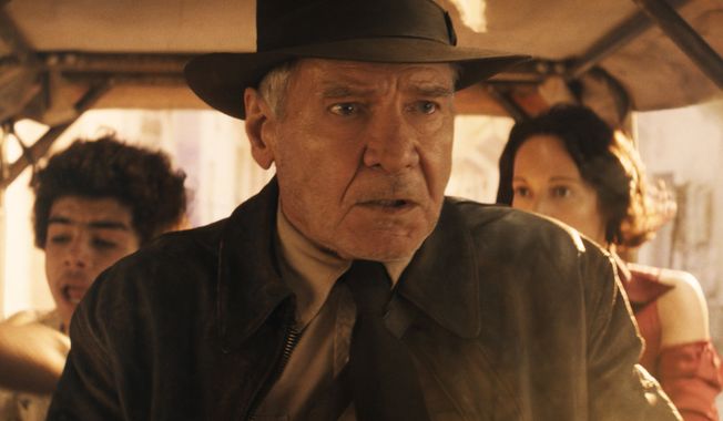 This image released by Lucasfilm shows Ethann Isidore, from left, Harrison Ford and Phoebe Waller-Bridge in a scene from &quot;Indiana Jones and the Dial of Destiny.&quot; (Lucasfilm Ltd. via AP)