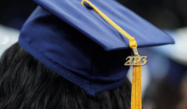 FILE - A tassel with 2023 on it rests on a graduation cap as students walk in a procession for Howard University&#x27;s commencement in Washington, Saturday, May 13, 2023. The Supreme Court is getting ready to decide some of its biggest cases of the term, including the fate of President Joe Biden鈥檚 plan to wipe away or reduce student loans held by millions of Americans. (AP Photo/Alex Brandon, File)