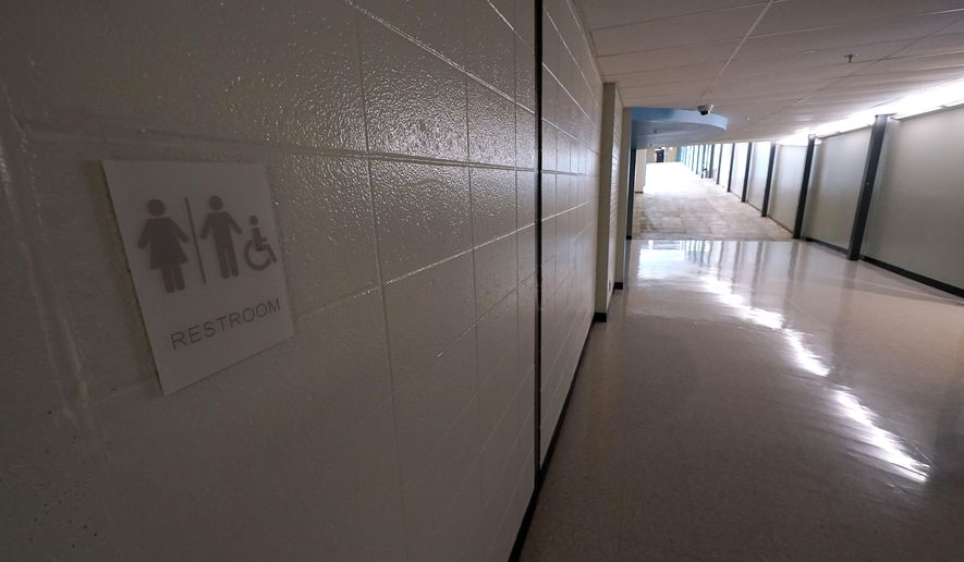 A sign for a newly-constructed gender neutral bathroom is seen at Shawnee Mission East High School, Friday, June 16, 2023, in Prairie Village, Kan. (AP Photo/Charlie Riedel)