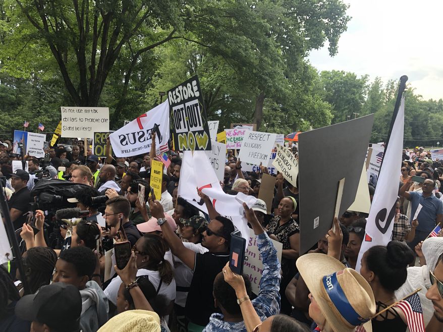Demonstrators attend a rally in Montgomery County, Maryland, on June 27, 2023, against the county school system's opt-out option for elementary reading materials that cover gay and transgender topics. (Matt Delaney/The Washington Times)