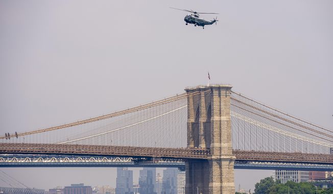 Marine One with President Joe Biden abroad flies over the Brooklyn Bridge as it arrives in New York, Thursday, June 29, 2023. (AP Photo/Andrew Harnik)