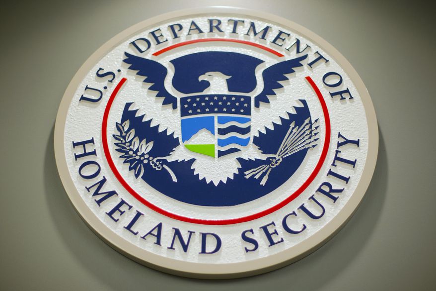 The Department of Homeland Security logo is seen during a news conference in Washington, Feb. 25, 2015. An Army combat veteran with extensive cybersecurity and counterterrorism experience is taking over as one of the nation’s top election security officials. Jen Easterly, the director of the U.S. Cybersecurity Infrastructure Security Agency, made the announcement Friday. In the position, Cait Conley will coordinate with federal, state and local officials responsible for ensuring elections are secure ahead of the 2024 election. (AP Photo/Pablo Martinez Monsivais, File)