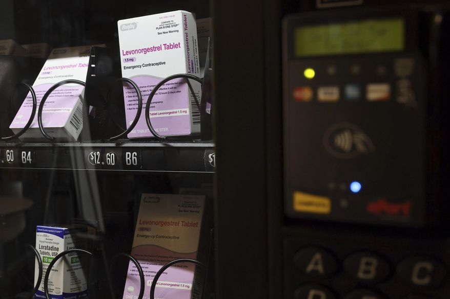 A vending machine is stocked with emergency contraceptives at Odegaard Library on the campus of the University of Washington, Friday, June 2, 2023, in Seattle. After a student-led campaign to install the emergency contraceptive vending machine on campus in November, boxes of generic Plan B have been available to students for $12.60, a fraction of the cost charged in stores. (Kevin Clark/The Seattle Times via AP)