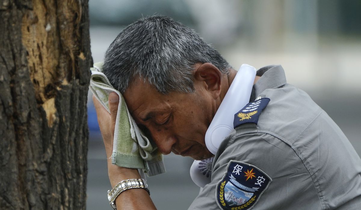 NextImg:Flooding displaces 10,000 around China as Beijing gets a relative respite from sweltering heat