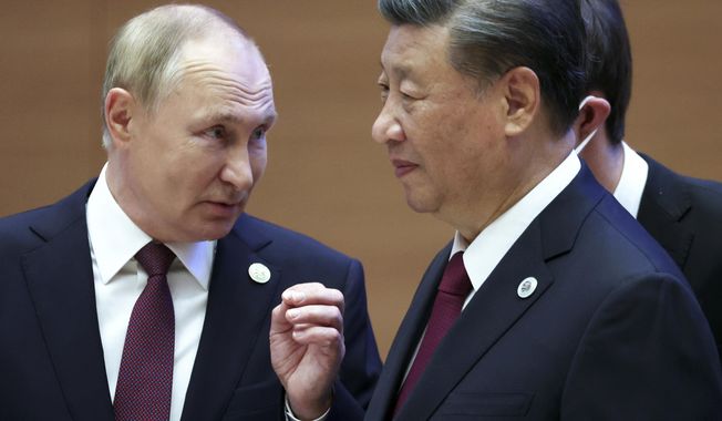 Russian President Vladimir Putin, left, gestures while speaking to Chinese President Xi Jinping during the Shanghai Cooperation Organization (SCO) summit in Samarkand, Uzbekistan, Sept. 16, 2022. Putin will this week participate in his first multilateral summit since an armed rebellion rattled Russia. Analysts say his participation at a virtual summit of the Shanghai Cooperation Organization on Tuesday is an opportunity to show he is in control after a short-lived insurrection by Wagner mercenary chief Yevgeny Prigozhin. (Sergei Bobylev, Sputnik, Kremlin Pool Photo via AP, File)