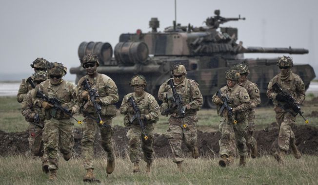 Servicemen of the United States 101 Airborne Division run during an exercise at the Mihail Kogalniceanu Air Base, near the Black Sea port of Constanta, Romania, Friday, March 31, 2023. Russia鈥檚 armed forces are bruised but by no means beaten in the war in Ukraine, a top NATO military officer said Monday, as he laid out the biggest revamp to the organization鈥檚 military plans since the Cold War should Moscow dare to widen the conflict. (AP Photo/Vadim Ghirda, File)