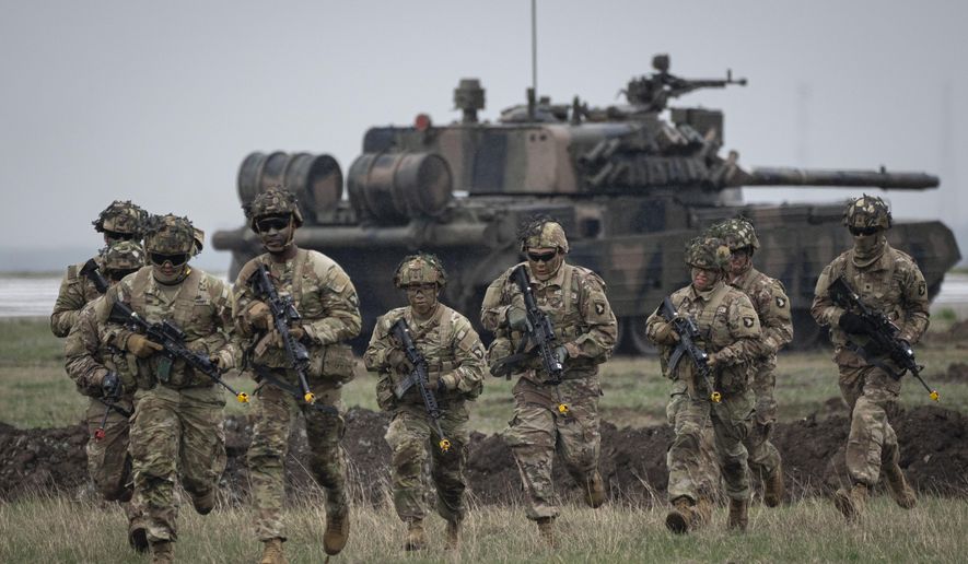 Servicemen of the U.S. 101 Airborne Division run during an exercise at the Mihail Kogalniceanu Air Base, near the Black Sea port of Constanta, Romania, Friday, March 31, 2023. (AP Photo/Vadim Ghirda, File)