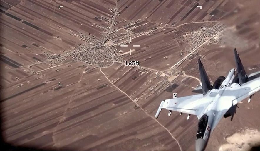 In this image from video released by the U.S. Air Force, a Russian SU-35 flies near a U.S. Air Force MQ-9 Reaper drone on Wednesday, July 5, 2023, over Syria. The U.S. Air Force says Russian fighter jets flew dangerously close to several U.S. drone aircraft over Syria, setting off flares and forcing the MQ-9 Reapers to take evasive maneuvers. (U.S. Air Force via AP)