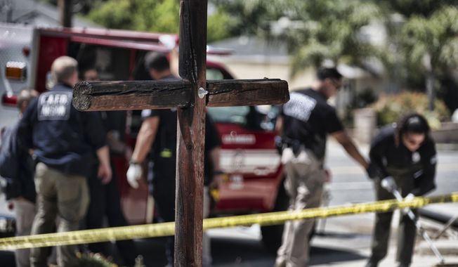 Los Angeles Fire Department Arson Unit personnel gather forensic evidence outside the Sylmar Christian Fellowship Church on Thursday, July 6, 2023, in the Sylmar section of Los Angeles. (AP Photo/Richard Vogel)