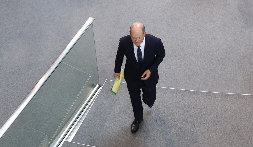 German Chancellor Olaf Scholz arrives during a meeting of the German federal parliament, Bundestag, at the Reichstag building in Berlin, Germany, Wednesday, July 5, 2023. (AP Photo/Michele Tantussi)