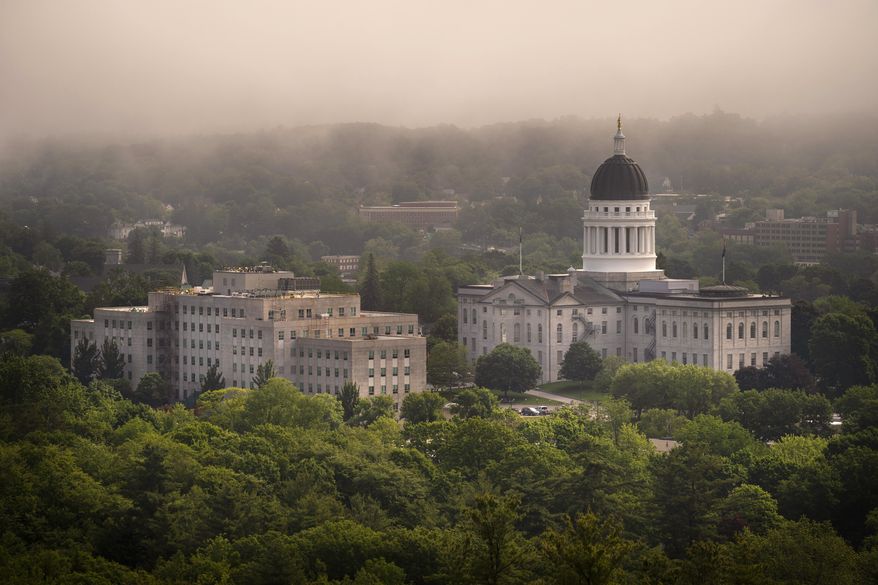 The morning fog lifts beyond the Burton M. Cross Building, left, and the State House, Wednesday, June 21, 2023, in Augusta, Maine. Maine lawmakers are meeting ,Thursday, July 6, 2023, for votes to enact a bill expand access to abortions and to override a bill to allow more federal laws to apply to Native American tribes in the State. (AP Photo/Robert F. Bukaty, File)