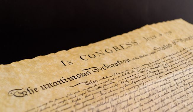 The Declaration of Independence and Constitution of the United States of America, isolated on black background. File photo credit: Roberti via Shutterstock.
