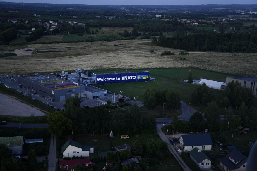 A banner for the NATO summit is visible from the air at the Vilnius airport in Vilnius, Lithuania, Monday, July 10, 2023. Russia's war on Ukraine will top the agenda when NATO leaders meet in the Lithuanian capital Vilnius on Tuesday and Wednesday. (AP Photo/Pavel Golovkin)