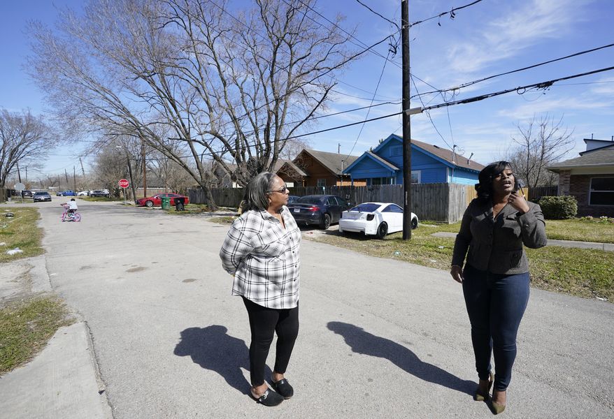 Kathy Blueford-Daniels, left, and Kendra London, right, both Fifth Ward residents and community activists, talk about health concerns in the area from the creosote contamination at the former Union Pacific Railroad site wood treatment facility shown Monday, Feb. 14, 2022, in Houston. Houston plans to spend millions of dollars to relocate residents from neighborhoods located near a rail yard polluted by a cancer-linked wood preservative that has been blamed for an increase in cancer cases, the city’s mayor announced Thursday, July 13, 2023. (Melissa Phillip/Houston Chronicle via AP)