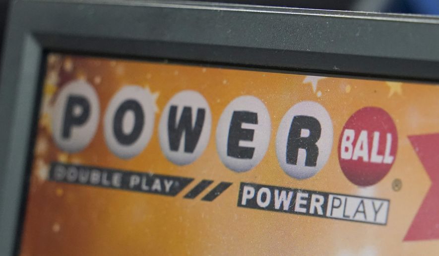 A display panel advertises tickets for a Powerball drawing at a convenience store, Nov. 7, 2022, in Renfrew, Pa. The Powerball jackpot soared to an estimated $875 million after no winning ticket was sold for the Wednesday, July 12, 2023, drawing. (AP Photo/Keith Srakocic, File)