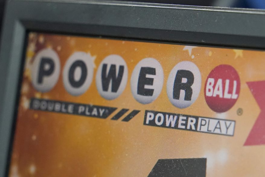 A display panel advertises tickets for a Powerball drawing at a convenience store, Nov. 7, 2022, in Renfrew, Pa. The Powerball jackpot soared to an estimated $875 million after no winning ticket was sold for the Wednesday, July 12, 2023, drawing. (AP Photo/Keith Srakocic, File)