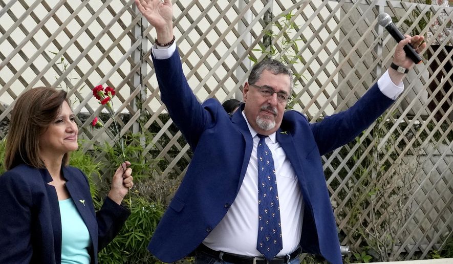 Bernardo Arévalo, presidential candidate with the Seed Movement party, and running mate Karin Herrera greet their followers outside Guatemala's Attorney General's office building in Guatemala City, Thursday, July 13, 2023. The Attorney General's Office announced on July 12 that a judge had suspended the legal status of the Seed Movement political party for alleged violations when it gathered the necessary signatures to form. Arévalo and Herrera had been set to compete in a runoff election on Aug. 20. (AP Photo/Moises Castillo)