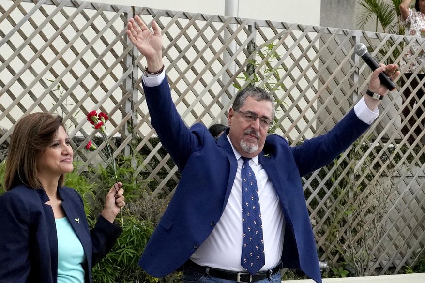 Bernardo Arévalo, presidential candidate with the Seed Movement party, and running mate Karin Herrera greet their followers outside Guatemala's Attorney General's office building in Guatemala City, Thursday, July 13, 2023. The Attorney General's Office announced on July 12 that a judge had suspended the legal status of the Seed Movement political party for alleged violations when it gathered the necessary signatures to form. Arévalo and Herrera had been set to compete in a runoff election on Aug. 20. (AP Photo/Moises Castillo)