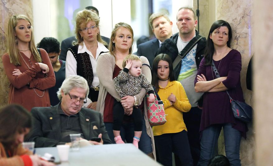 Parents with their children and medical professionals listen to testimony from people who want Mississippi to allow a religious exemption from the vaccination requirements for school attendance, during a legislative committee meeting on Jan. 24, 2018, at the Capitol in Jackson, Miss. Under an order from a federal judge, the Mississippi State Department of Health is publishing information Saturday, July 15, 2023, about how people can apply for religious exemptions from childhood vaccinations. (AP Photo/Rogelio V. Solis, File)