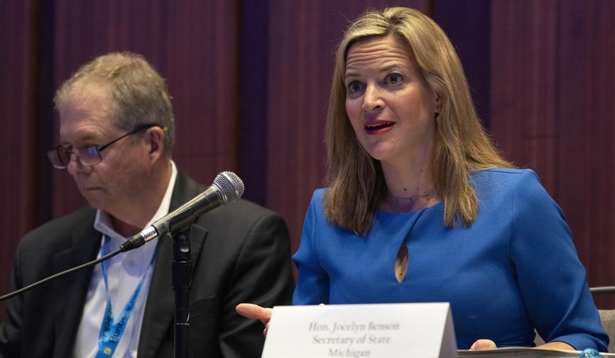 Jocelyn Benson, Michigan's Secretary of State, right, attends a panel about elections during the summer meeting of the National Association of Secretaries of State, Tuesday, July 11, 2023, in Washington. Efforts to deceive the public about voting and elections remain a top concern for state election officials as they dig into preparations for the 2024 election. (AP Photo/Jacquelyn Martin)