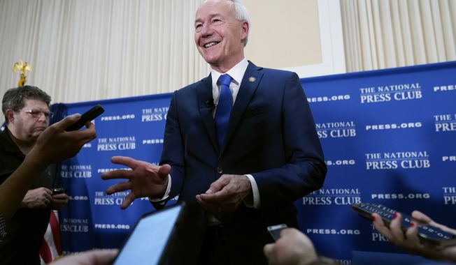 Republican presidential candidate, former Arkansas Gov. Asa Hutchinson speaks with members of the press after an event at the National Press Club in Washington, Monday, July 17, 2023. (AP Photo/Patrick Semansky)