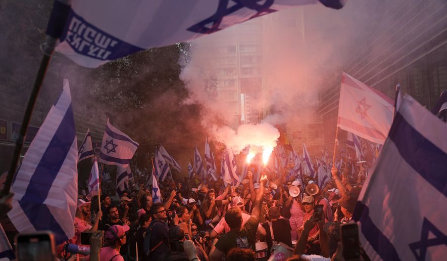 Israelis protest against plans by Prime Minister Benjamin Netanyahu&#x27;s government to overhaul the judicial system in Tel Aviv, Israel, Tuesday, July 18, 2023. (AP Photo/Oded Balilty)
