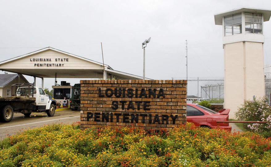 Vehicles enter the main security gate at the Louisiana State Penitentiary — Angola Prison, the largest high-security prison in the country in Angola, La., Aug. 5, 2008. In a federal court filing dated Monday, July 17, 2023, advocates said that juveniles held in a former death row building at the Louisiana prison for adults are suffering through dangerous heat and psychologically damaging isolation in their cells with little or no mental health care, inadequate schooling and foul water. In the filing, advocates asked a judge to order that the youths be moved. (AP Photo/Judi Bottoni, File)