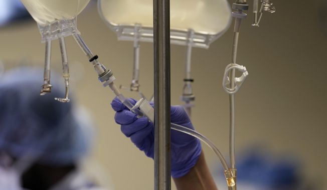 Fluids are controlled in an operating room in a hospital in Jackson, Tenn., on June 15, 2023. On Thursday, July 20, 2023, the Biden administration asked employers to give workers who lose Medicaid coverage more time to sign up for health insurance through their jobs. (AP Photo/Mark Humphrey)