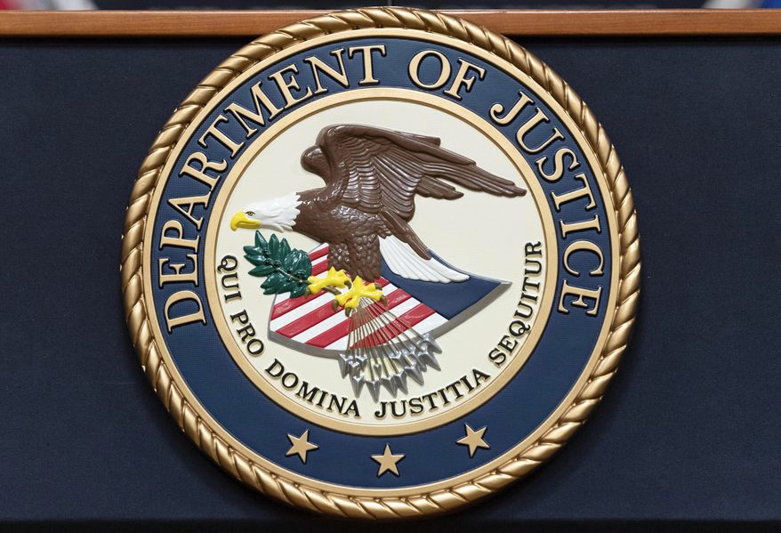 The Department of Justice seal is seen before a news conference to announce an international ransomware enforcement action at the Department of Justice in Washington, Jan. 26, 2023. On Friday, July 21, The Associated Press reported on stories circulating online incorrectly claiming the U.S. Department of Justice said international child sex trafficking is not an area of concern. (AP Photo/Jose Luis Magana, File)