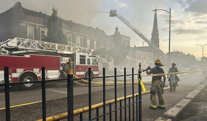 Members of the Bowling Green Fire Department work to extinguish an early morning structure fire on State Street Friday, July 21, 2023 in Bowling Green, Ky.  The building, home to Senator Rand Paul&#x27;s Bowling Green local office, sustained heavy damage, including a roof collapse. (Jake Moore/Daily News via AP)