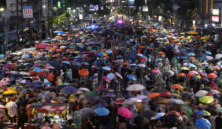 Supporters of the Move Forward Party walk in a circle during a protest in Bangkok, Thailand, Sunday, July 23, 2023. The demonstrators are protesting that Thailand's Constitution is undemocratic, because it allowed Parliament to block the winner of May's general election, the Move Forward Party, from naming its leader named the new prime minister, even though he had assembled an eight-part coalition that had won a clear majority of seats in the House of Representatives. (AP Photo/Sakchai Lalit)