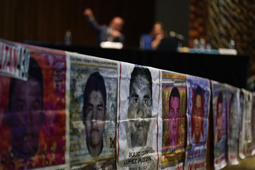 Photographs of missing students are displayed during a press conference by the Interdisciplinary Group of Independent Experts (GIEI) in Mexico City, Tuesday, July 25, 2023. The GIEI presented its sixth and last report on the case of the 43 students from Ayotzinapa who disappeared on Sept. 26, 2014. (AP Photo/Eduardo Verdugo)
