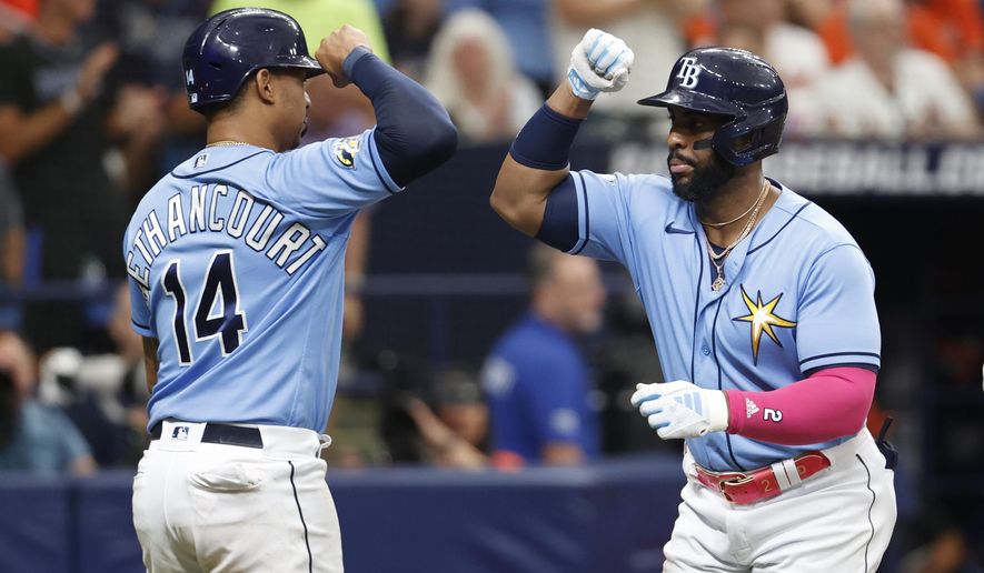 Tampa Bay Rays' Yandy Diaz, right, celebrates with teammate Christian Bethancourt after hitting a two-run home run against the Baltimore Orioles during the fifth inning of a baseball game, Sunday, July 23, 2023, in St. Petersburg, Fla. (AP Photo/Scott Audette)