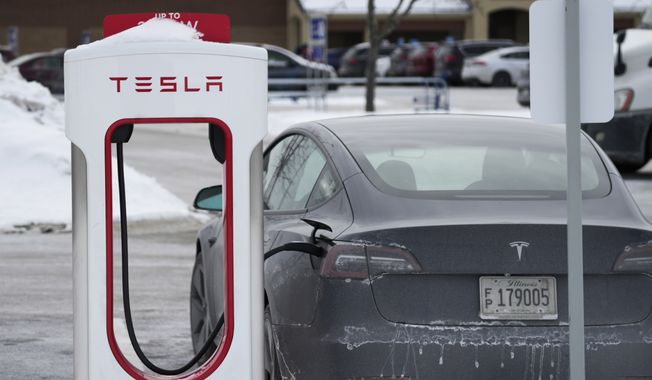 Tesla Supercharger is seen in Rolling Meadows, Ill., Monday, Jan. 30, 2023. The second-largest electric vehicle fast-charging network, Electrify America, with 800 direct-current fast-charging stations and more than 3,600 plugs nationwide, said Wednesday, July 26, 2023, it will work to add Tesla&#x27;s connector to existing and future chargers by 2025. (AP Photo/Nam Y. Huh, File)