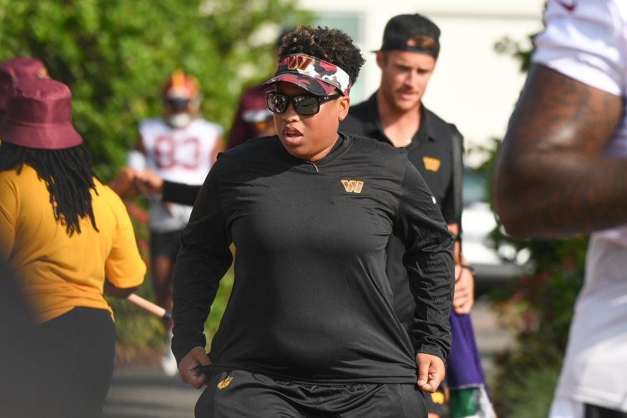 Washington Commanders assistant running backs coach Jennifer King heads towards the field during the second day of training camp at the OrthoVirginia Training Center at Commanders Park in Ashburn, Virginia, July 28, 2023. (Photo by Billy Sabatini)