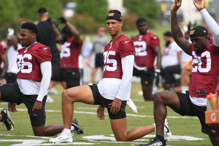 Washington Commanders cornerback Benjamin St-Juste (25) doing stretching exercises during the second day of training camp at the OrthoVirginia Training Center at Commanders Park in Ashburn, Virginia, July 28, 2023. (Photo by Billy Sabatini)