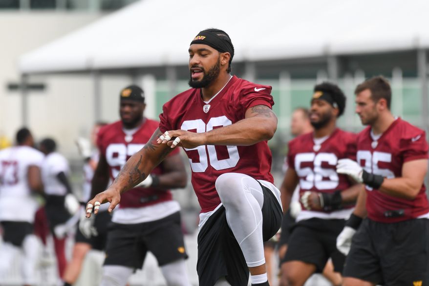 Washington Commanders defensive end Montez Sweat (90) doing stretching exercises during the second day of training camp at the OrthoVirginia Training Center at Commanders Park in Ashburn, Virginia, July 28, 2023. (Photo by Billy Sabatini)