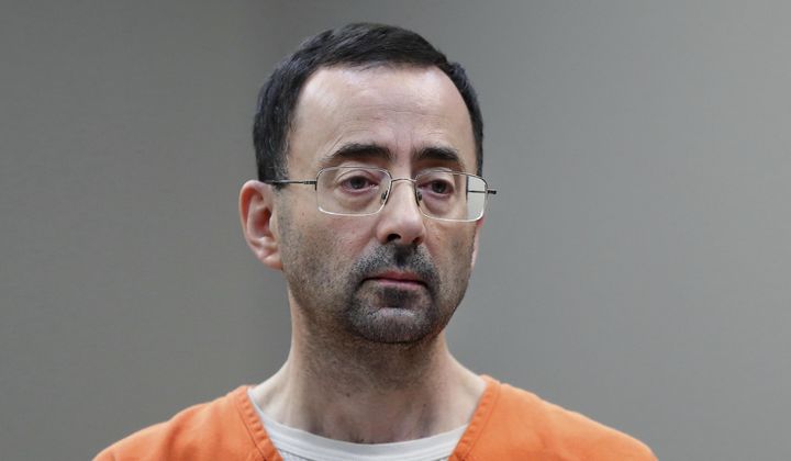 Disgraced former sports doctor Larry Nassar appears in court for a plea hearing, Nov. 22, 2017, in Lansing, Mich. Women sexually assaulted by imprisoned former Michigan State University sports doctor Larry Nassar have filed a lawsuit, Thursday, July 27, 2023, claiming school officials made “secret decisions” about releasing documents in the case. (AP Photo/Paul Sancya, File)